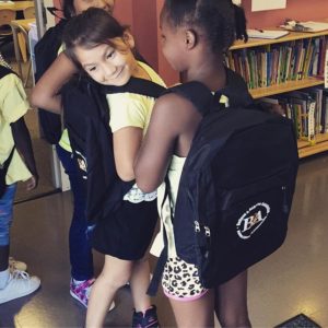 Girls wearing Believe & Achieve Backpacks