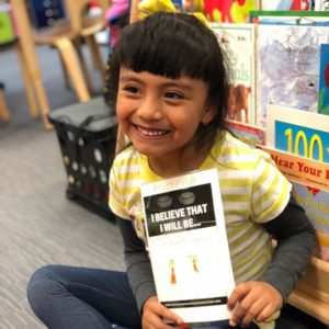 Girl holding sign that she made